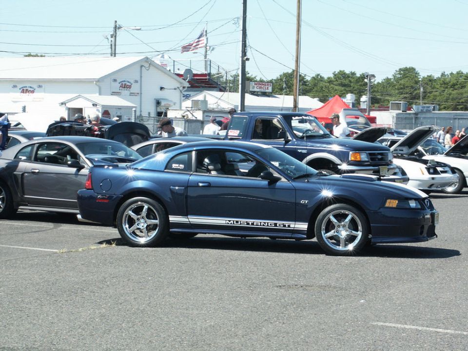 Blue 2001 Ford Mustang GT with GT side stripe, parked at a car show
