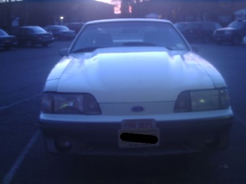 1989 Ford Mustang - Front view of a 1989 Ford Mustang GT parked in a lot at dusk.