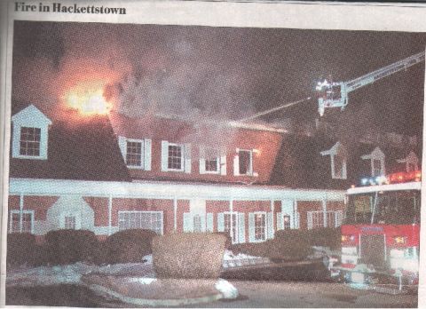 1989 Ford Mustang - A fire truck responds to a building fire, with smoke billowing from the roof and flames visible.