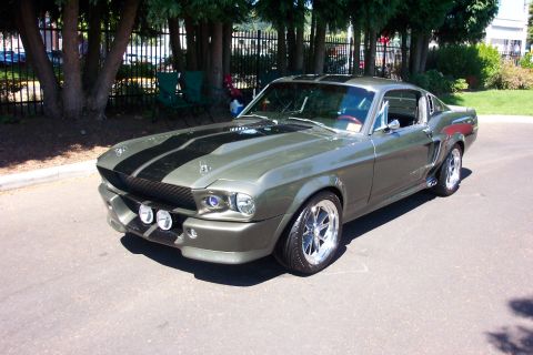 1970 Chevrolet Camaro - This 1967 Ford Mustang Shelby GT500 features a distinctive green paint job with dual black racing stripes and front fog lights.