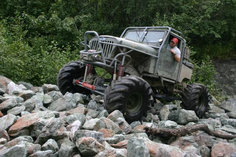2003 Jeep TJ - Custom Jeep CJ-series off-road vehicle navigating a rocky terrain.