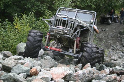 2003 Jeep TJ - This heavily modified vehicle is attempting to traverse a challenging rocky terrain.