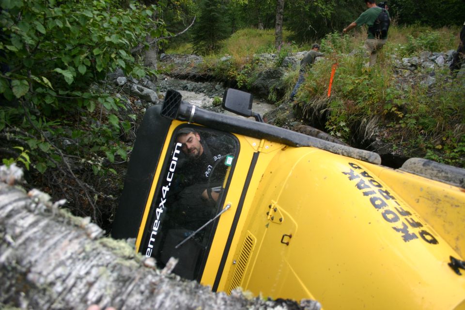 Yellow 2003 Jeep TJ overturned in a ditch with "KODIAK OFF-ROAD" and "extreme4x4.com" text visible
