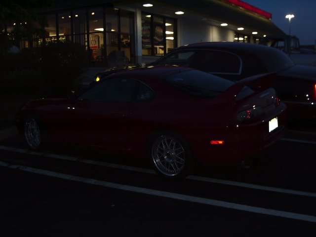 Red sports car side view at night