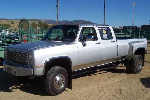 1994 Ford F-150 - This pickup truck features a quad cab and dual rear wheels, indicating a heavy-duty configuration.