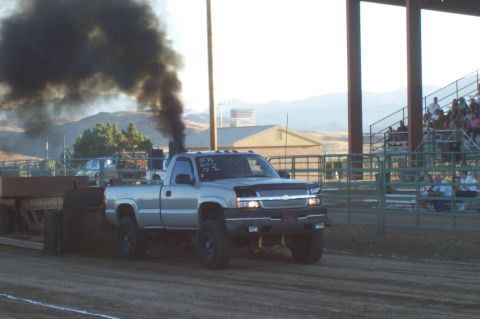 1994 Ford F-150 - A diesel truck is seen during a pull event, emitting a large cloud of black smoke.