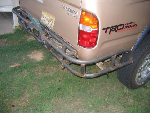 1999 Toyota Tacoma - Rear view of a 1999 Toyota Tacoma pickup truck a custom off-road bumper and TRD Off Road badging.