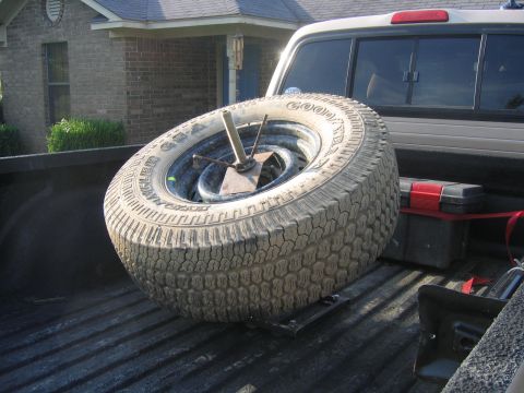 1999 Toyota Tacoma - A spare tire and toolbox are secured in the bed of a pickup truck.
