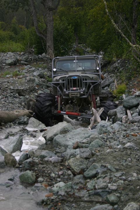 2003 Jeep TJ - This heavily modified Jeep navigates a rocky stream bed, its off-road capabilities.