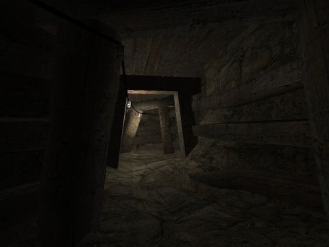 1969 Ford Mustang - Interior view of a dimly lit mine tunnel, showing rough-hewn walls and timber supports.