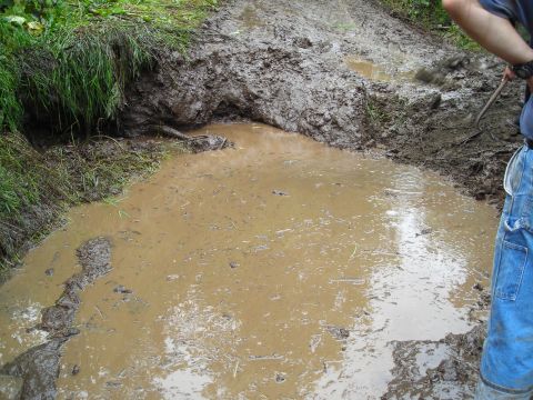 2003 Jeep TJ - The mudhole that was nothing when everyone came in. With the increased rain, it turned into quite a obstacle that we will be returning to f…