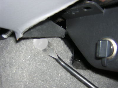 2000 Ford Crown Victoria - Removing this plastic pin holding the carpet aids in removing that lower panel.