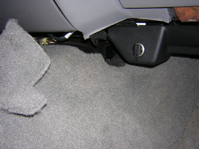 2000 Ford Crown Victoria - Carpet is pulled back to aid in removing the lower plastic panel.