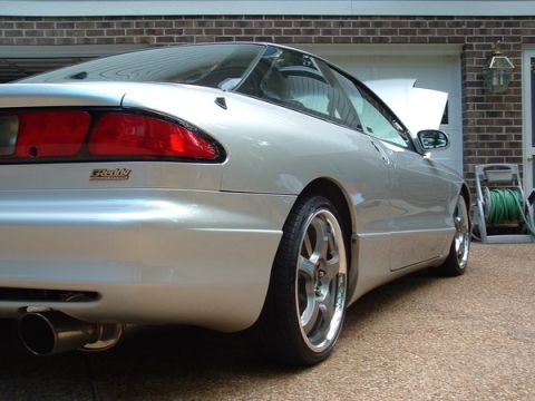 1993 Ford Probe - Rear quarter view of a silver 1993 Ford Probe, aftermarket wheels and a modified exhaust.