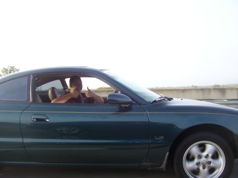 1994 Ford Probe - Driver gives a thumbs up from inside a 1994 Ford Probe coupe.