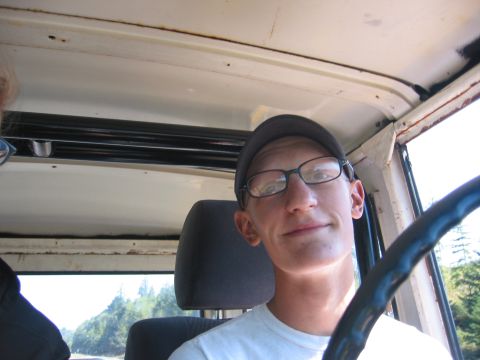 1991 Ford Explorer - A man with glasses and a cap looks at the camera from inside a vehicle.