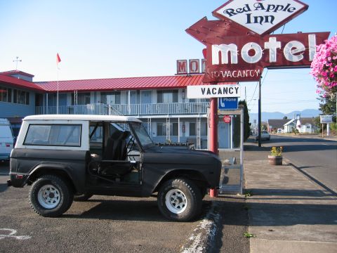 1991 Ford Explorer - A classic Ford Bronco sits parked outside the Red Apple Inn motel.