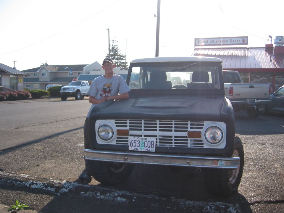 Ford Bronco front view with a person leaning on the hood. License plate reads 653 COB