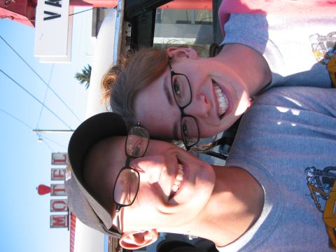 1991 Ford Explorer - A motel sign with a red apple logo is visible behind two smiling individuals.