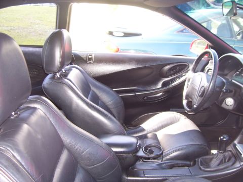 1994 Ford Probe - The interior of a 1994 Ford Probe features black leather seats and a view of the dashboard and steering wheel.