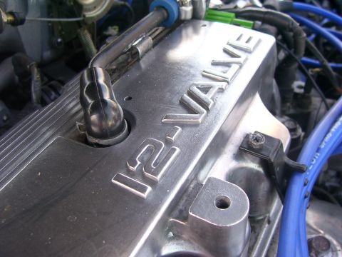 1994 Ford Probe - Close-up of an engine's aluminum valve cover, showing "16-VALVE" in raised lettering.