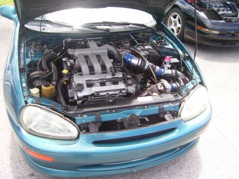 1994 Ford Probe - Engine bay of a 1994 Ford Probe, modified with a turbocharger, is shown next to another Probe.