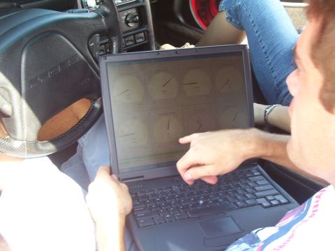 1994 Ford Probe - A laptop displays engine performance data inside a vehicle's cabin.