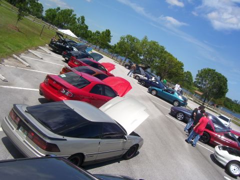 1994 Ford Probe - Multiple cars, including a silver 1994 Ford Probe, are parked in an outdoor lot with their hoods open.