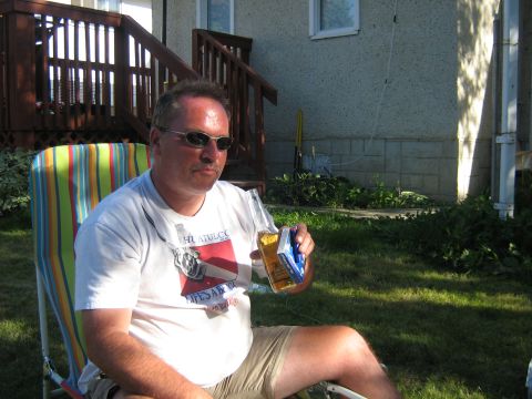 1995 Ford Bronco - A man relaxes outdoors in a lawn chair with a beer in hand.