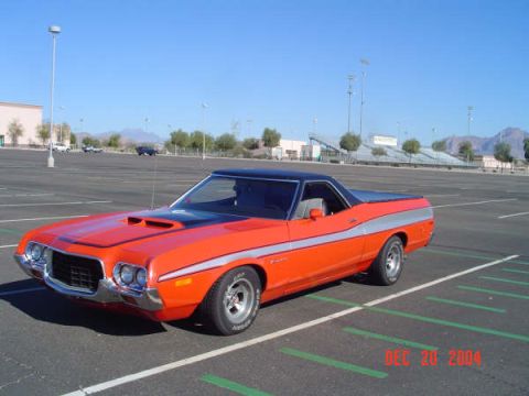 1973 Ford Ranchero - This orange 1973 Ford Ranchero has a black vinyl top and a silver stripe along its side.