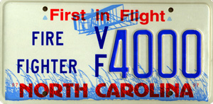 1998 Ford Crown Victoria - North Carolina license plate with "First in Flight" slogan and "Fire Fighter" designation.