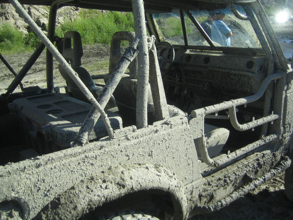 Mud-covered off-road vehicle interior and side view
