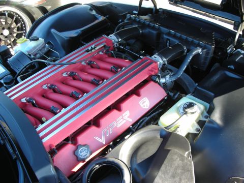 1998 Ford Crown Victoria - red intake manifold stamped VIPER fills the open engine bay of a Dodge Viper.