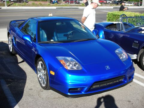 1998 Ford Crown Victoria - bright blue Acura NSX coupe sits in a parking lot at a car show with a Shelby Cobra replica beside it.