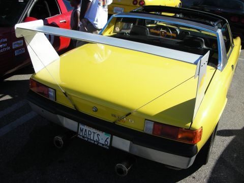 1998 Ford Crown Victoria - Rear three-quarter of a yellow Porsche 914 targa with a tall rear wing and a license plate reading MARTS 6.