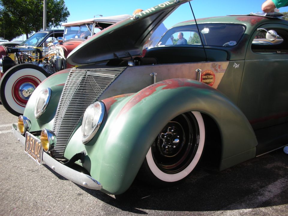 Lowered green patina 1930s Ford coupe with black steelies and whitewalls