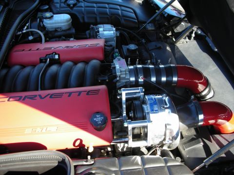 1998 Ford Crown Victoria - C5 Corvette LS engine with red Corvette covers, a centrifugal supercharger and red intercooler piping.