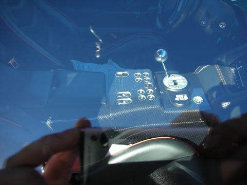 1998 Ford Crown Victoria - Through a tinted windshield, a carbon-fiber center console with toggle switches and a chrome ball-topped gated shifter.