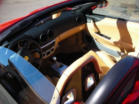 1998 Ford Crown Victoria - Interior of a red convertible Ferrari with tan and black leather, a gated manual shifter and prancing-horse steering wheel emblem.