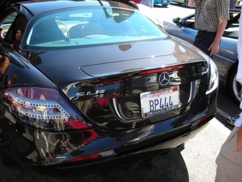 1998 Ford Crown Victoria - Rear of a black Mercedes-Benz SLR showing the chrome SLR badge and a California Beverly Hills license plate reading BP444.