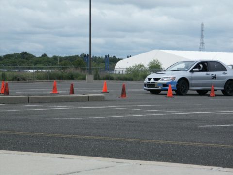 2001 Mercury Grand Marquis - Silver sedan with blue accents and number 54 on door participates in a cone course event.