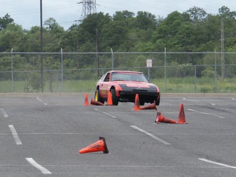 2001 Mercury Grand Marquis - Sports car maneuvering through a cone course in an open lot.