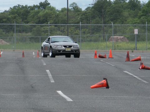 2001 Mercury Grand Marquis - A gray Ford Mustang navigates an autocross course marked by orange traffic cones.