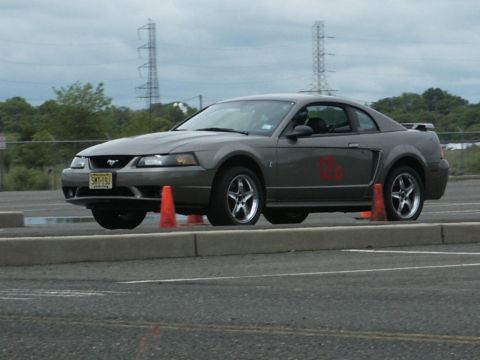 2001 Mercury Grand Marquis - A gray Ford Mustang coupe navigates a course marked by orange cones.