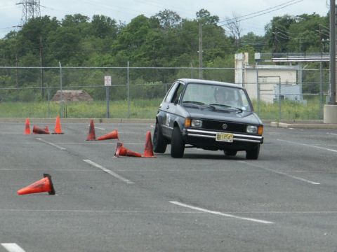 2001 Mercury Grand Marquis - A Volkswagen Golf navigates a cone course in an asphalt parking lot.
