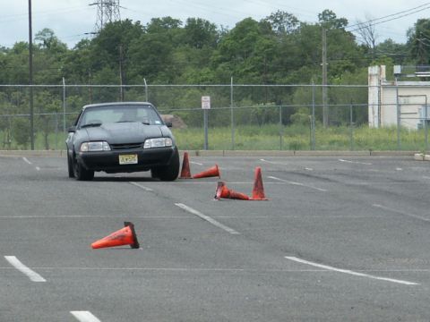 2001 Mercury Grand Marquis - A black sedan navigates a cone course in an asphalt lot.