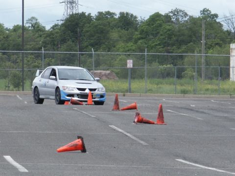 2001 Mercury Grand Marquis - A silver Mitsubishi Lancer Evolution navigates a course marked by traffic cones in an asphalt lot.