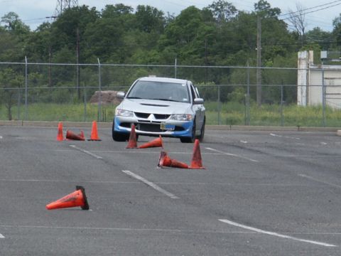 2001 Mercury Grand Marquis - A silver sedan with blue accents drives through an autocross course marked by orange cones.
