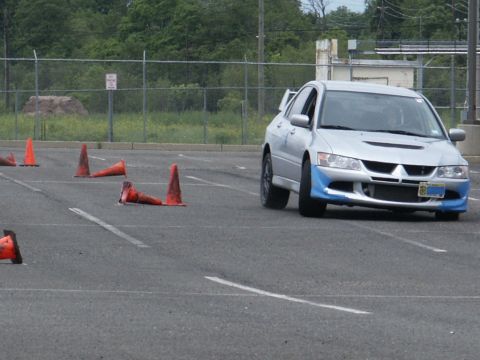 2001 Mercury Grand Marquis - A silver sports sedan is shown maneuvering through a course marked by traffic cones in an asphalt lot.