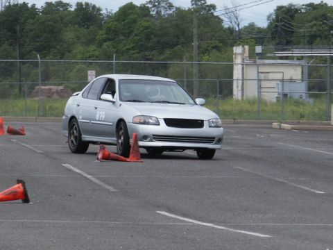 2001 Mercury Grand Marquis - Silver sedan with racing cones on a paved course, likely during a timed event.
